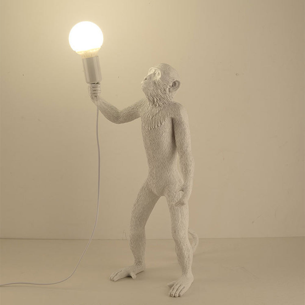 Modern monkey table lamp as bedroom decor element