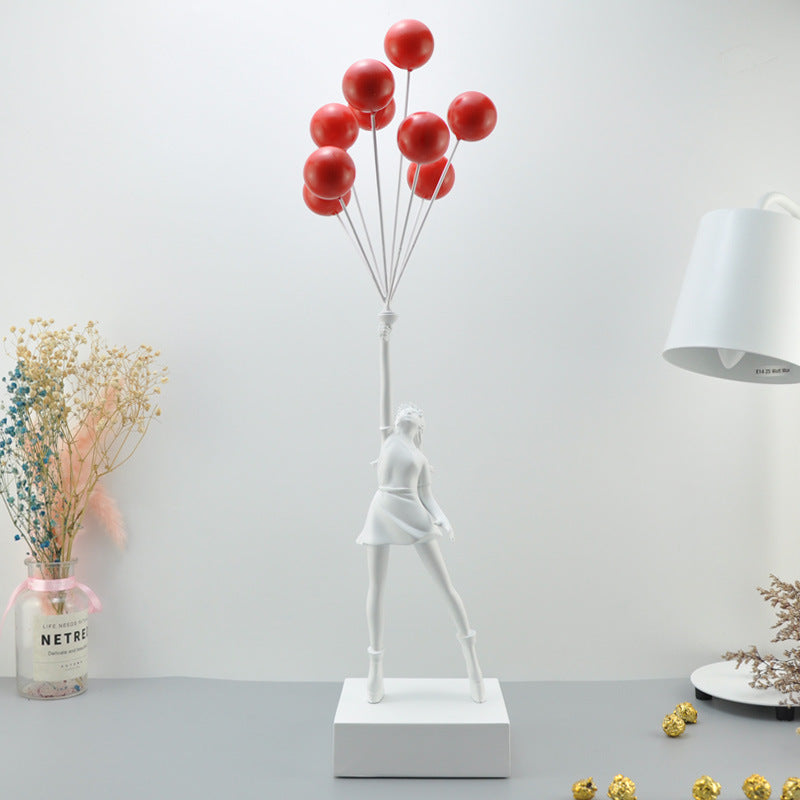 Statua moderna di bambina con palloncino