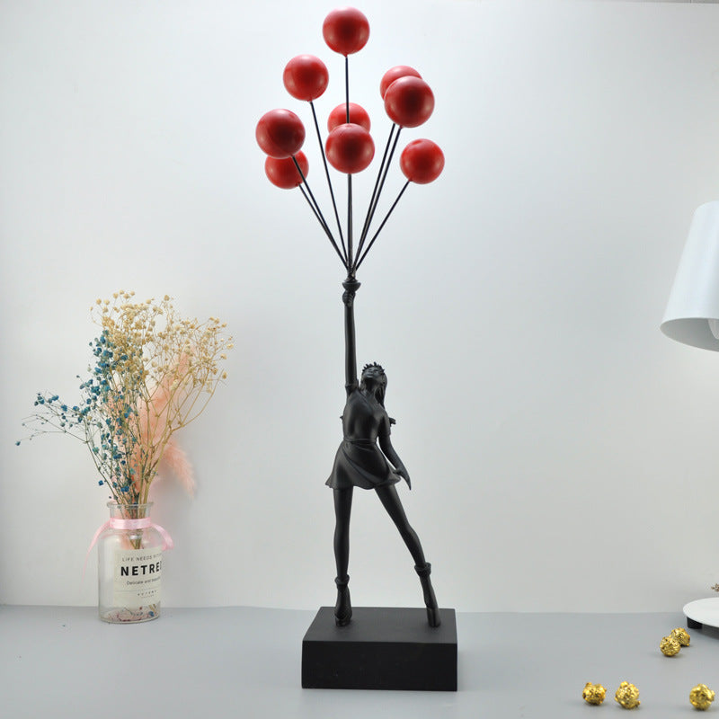 Statua moderna di bambina con palloncino
