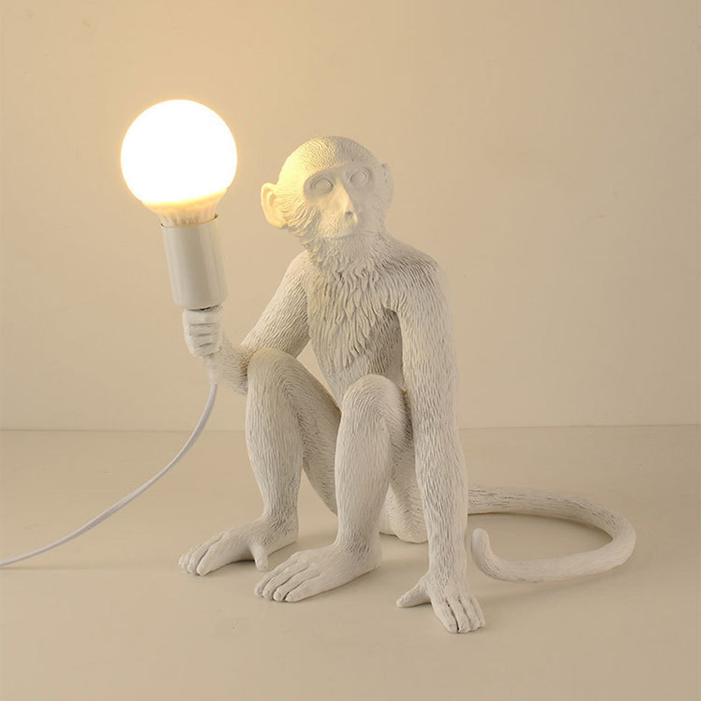 Modern monkey table lamp as bedroom decor element