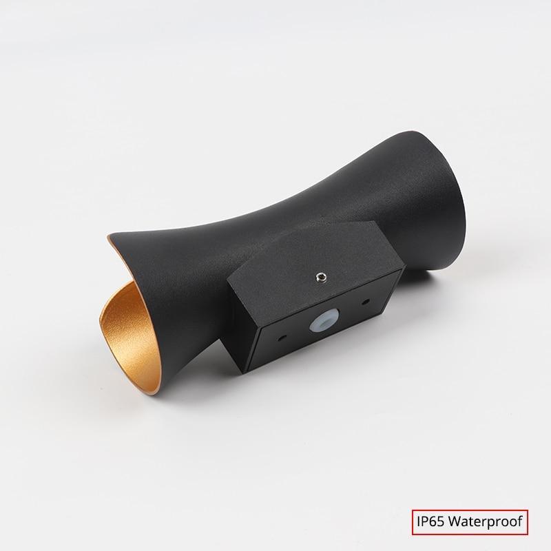 Modern outdoor LED wall light with curved design directing light up and down