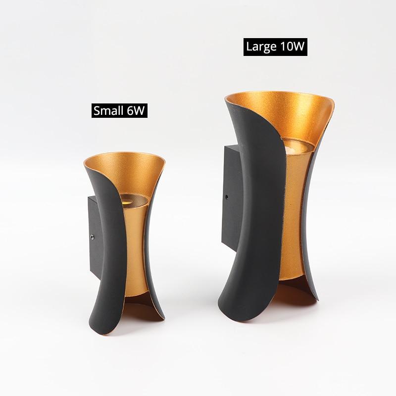 Modern outdoor LED wall light with curved design directing light up and down