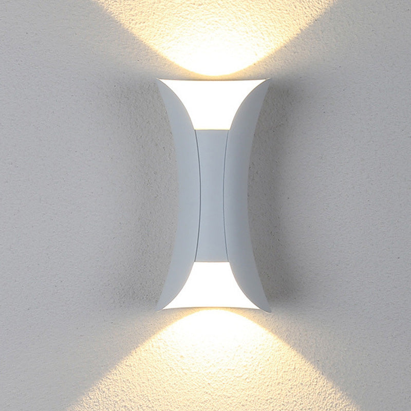 Modern outdoor LED wall light with curved design directing light up and down