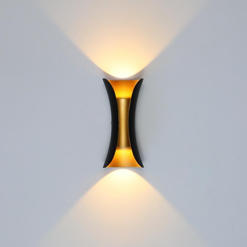 Modern outdoor LED wall light with curved design directing light up and down