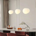 Artistic pendant lamp with frosted glass and pebbles for dining rooms and living rooms