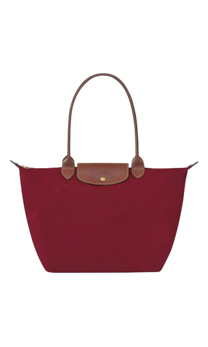 Women's handbag with a minimalist style, rigid shape, and handle
