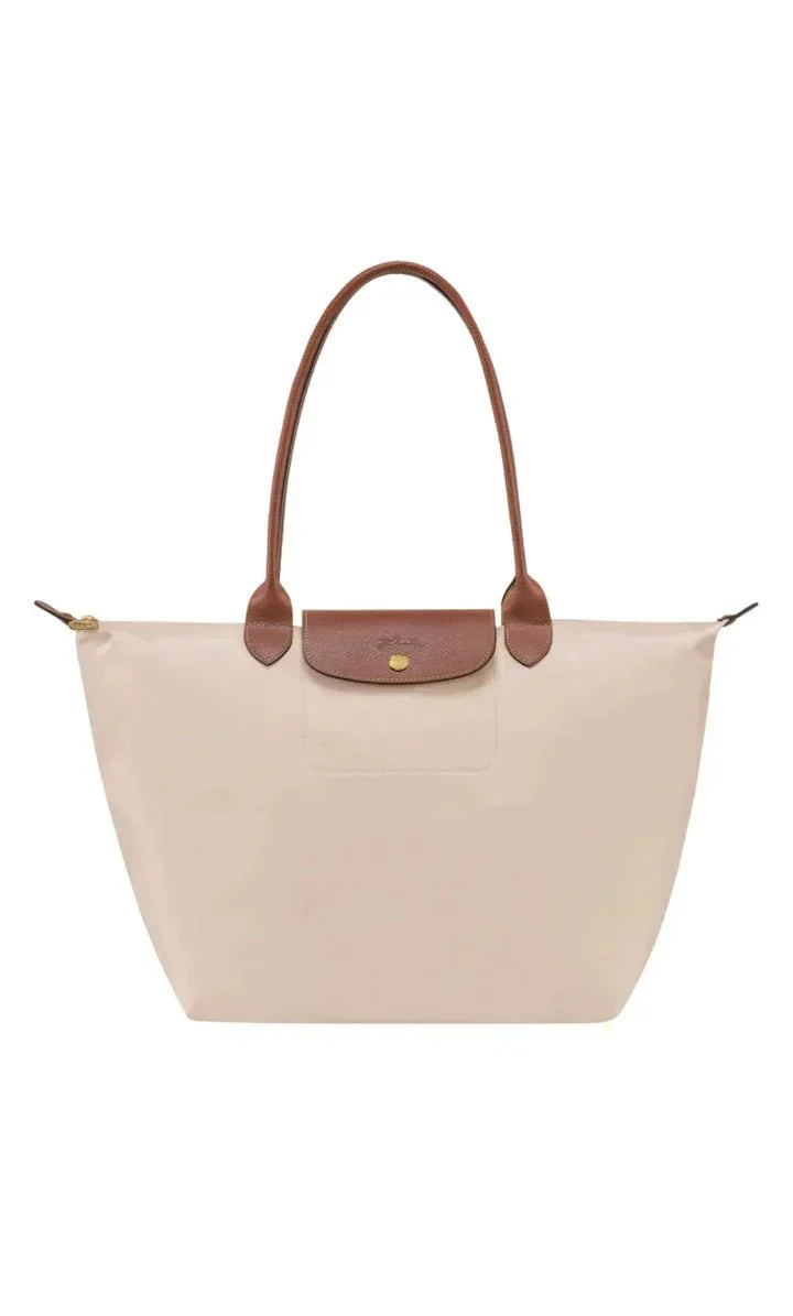 Women's handbag with a minimalist style, rigid shape, and handle