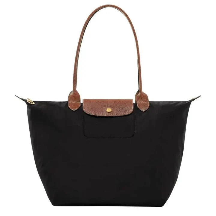 Women's handbag with a minimalist style, rigid shape, and handle